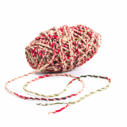 Multicolored yarn ball with a string on a white background