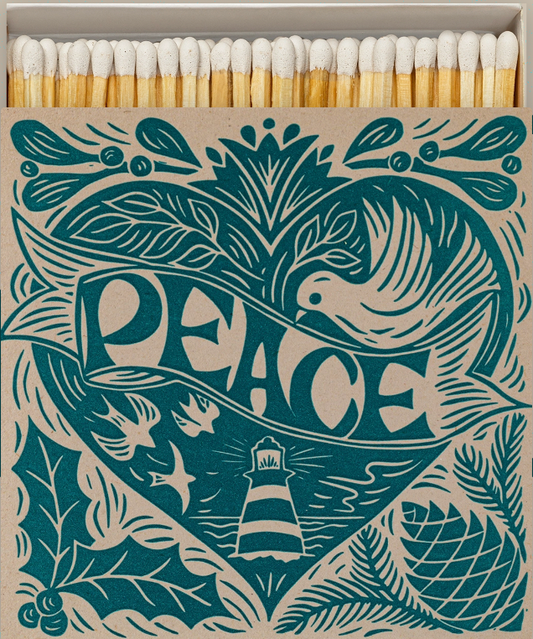 Matches with decorative box featuring a bird, lighthouse, and 'PEACE' text.